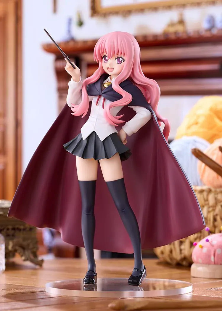 POP UP PARADE Louise L Size figure with flowing pink hair, a raised wand, white blouse, dark skirt, and a cape with burgundy lining.