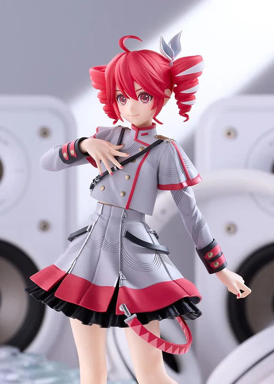 Kasane Teto Synthesizer V AI figure with red drill curls, a gray and red outfit, layered skirt, and black lace-up boots, posed with one hand across her chest.
