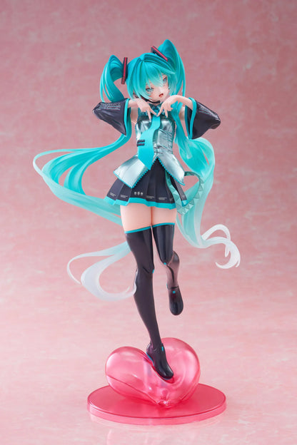 Hatsune Miku T-Most figure with flowing twin tails, classic Vocaloid outfit, and pink heart-shaped display base