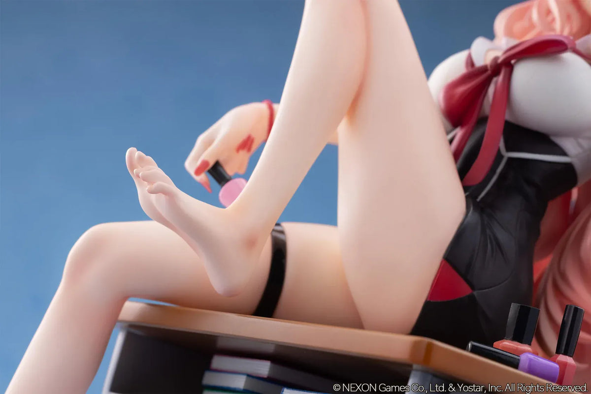 Blue Archive Kirara figure with long pink hair, black horns, and a pink halo, seated on a classroom desk beside nail polish bottles.