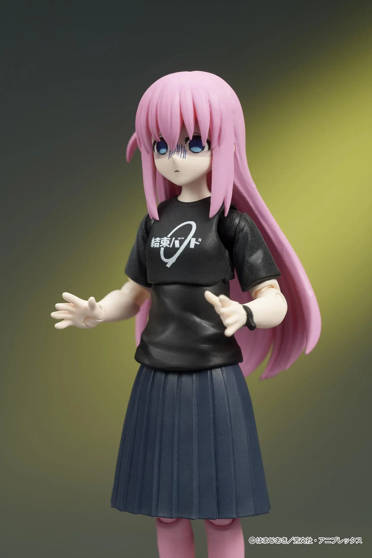 Bocchi the Rock! DIGACTION Hitori Gotoh figure holding a black and gold guitar, wearing a black band T-shirt, dark skirt, and pink leggings.