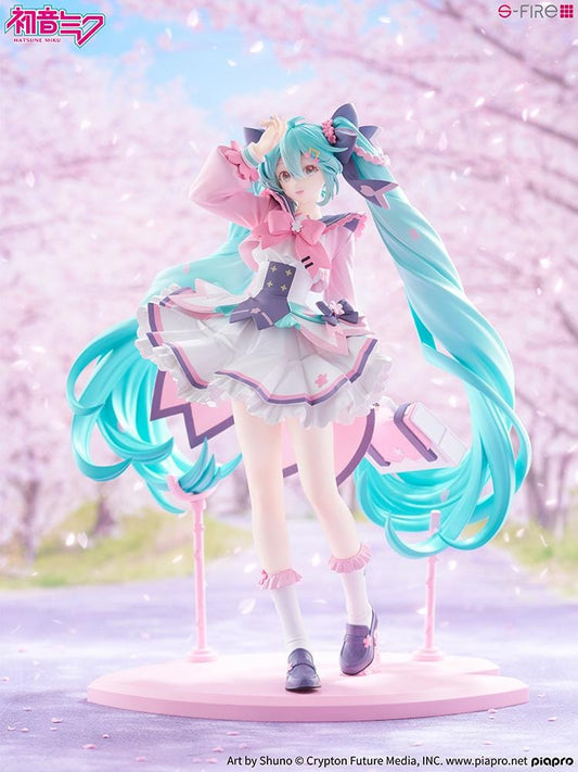 Hatsune Miku New School Term figure with turquoise twin-tails, a pink and white ruffled outfit, purple bows, and flower accents on a pink base.