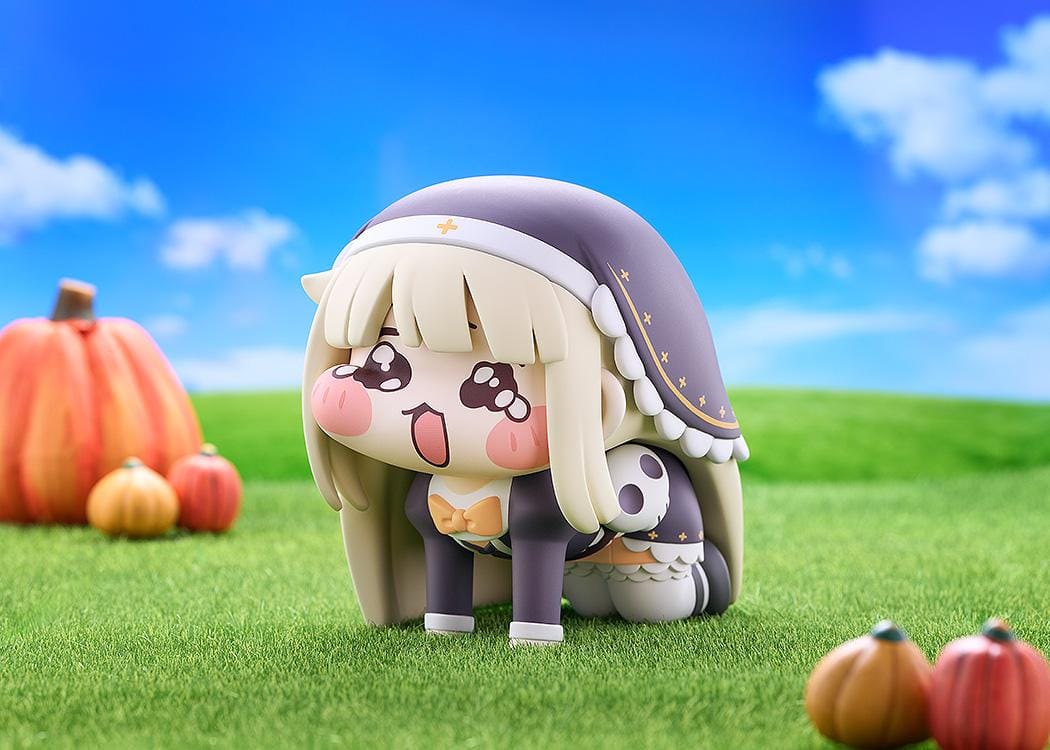 Petite Speaki soft vinyl figure with blonde hair, rosy cheeks, sparkling eyes, and a dark hood with gold accents.