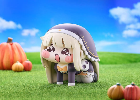 Petite Speaki soft vinyl figure with blonde hair, rosy cheeks, sparkling eyes, and a dark hood with gold accents.