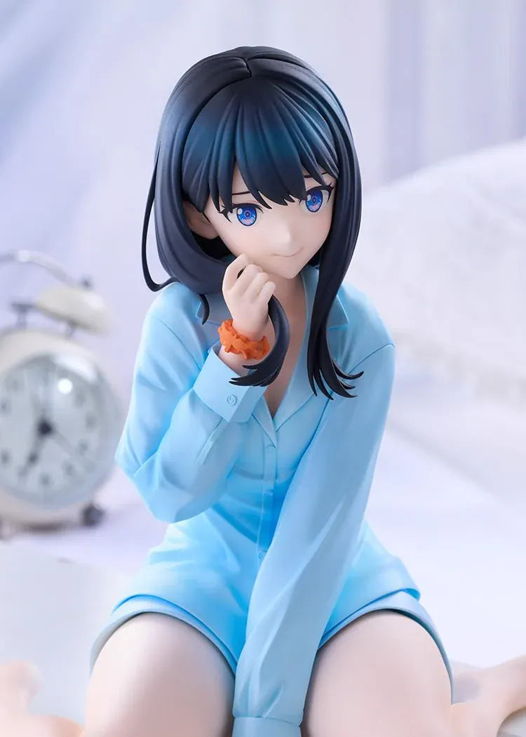 GRIDMAN UNIVERSE Rikka Takarada Pajamas Ver. figure seated in light blue pajamas, with dark hair, blue eyes, and an orange wrist scrunchie.