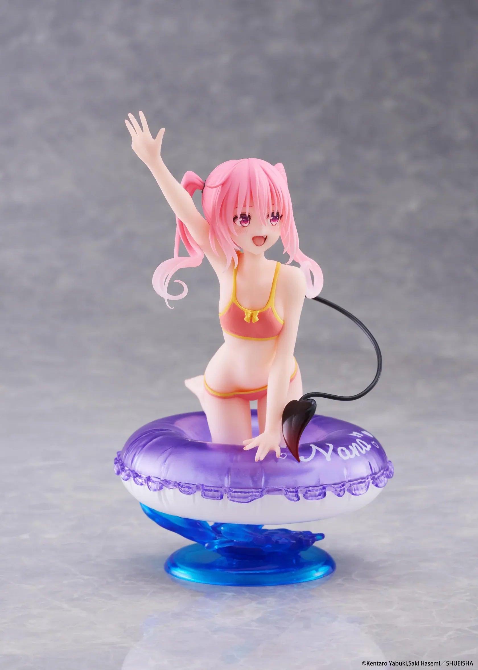 To Love-Ru Darkness Aqua Float Girls Nana figure featuring Nana with pink twin tails in a swimsuit posing on a purple float ring display base