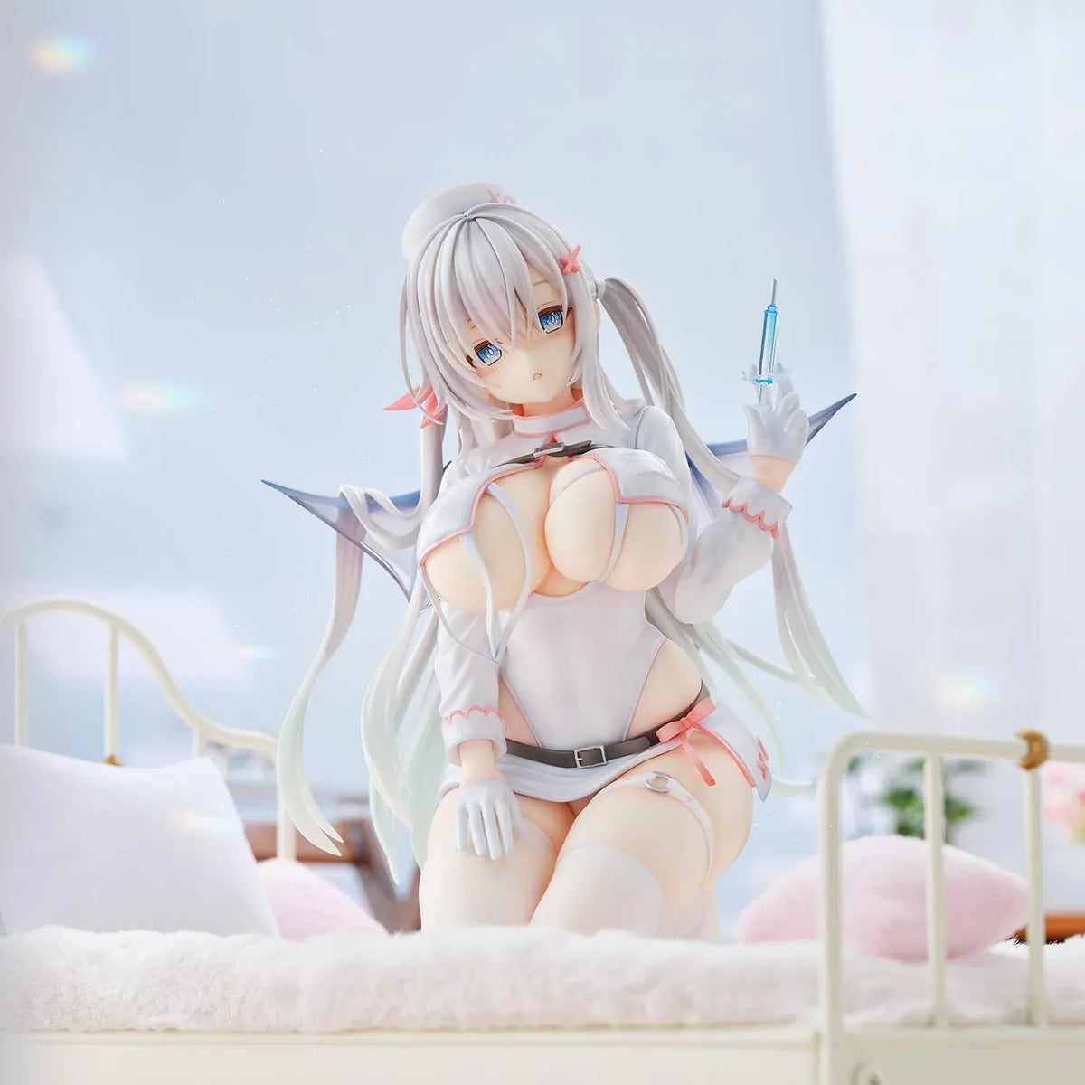 Succubus Nurse Makina figure kneeling in a white and pink nurse outfit with silver hair, batlike wings, a demon tail, and a translucent syringe.