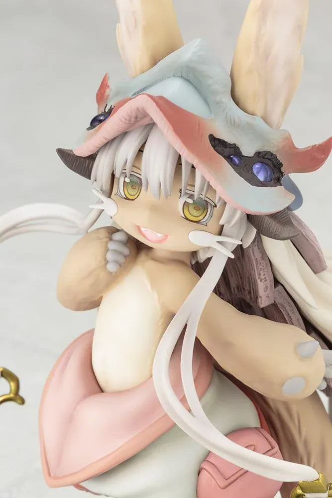 Made in Abyss The Awakening Mystery Nanachi Figure (Rerelease) featuring a fluffy rabbit-like character with long cream-colored ears, golden eyes, an oversized explorer hat, pink and beige clothing, and long flowing hair standing on a detailed scenic base with green moss, rocks, and blue water.