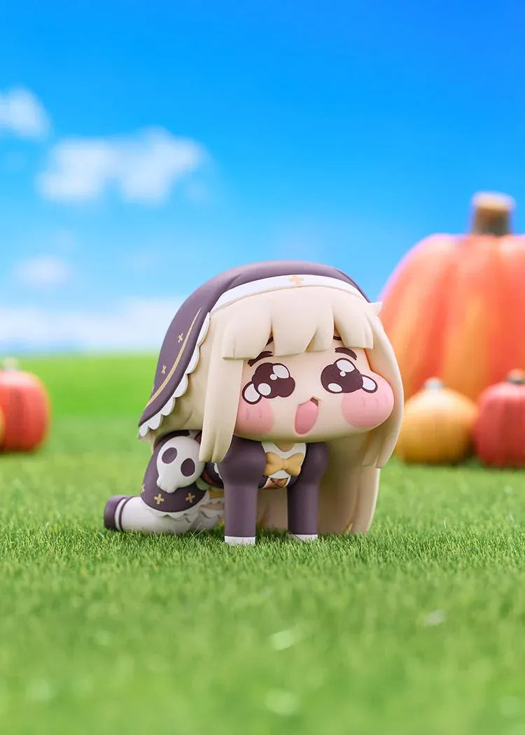 POP UP PARADE Petite Speaki figure with blonde hair, sparkling eyes, rosy cheeks, and a dark hood with gold accents and a skull detail.