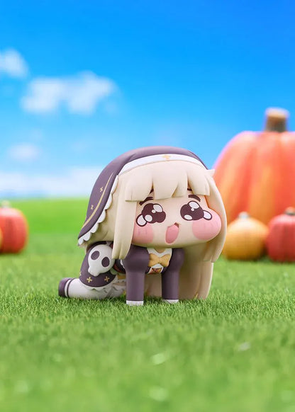 POP UP PARADE Petite Speaki figure with blonde hair, sparkling eyes, rosy cheeks, and a dark hood with gold accents and a skull detail.
