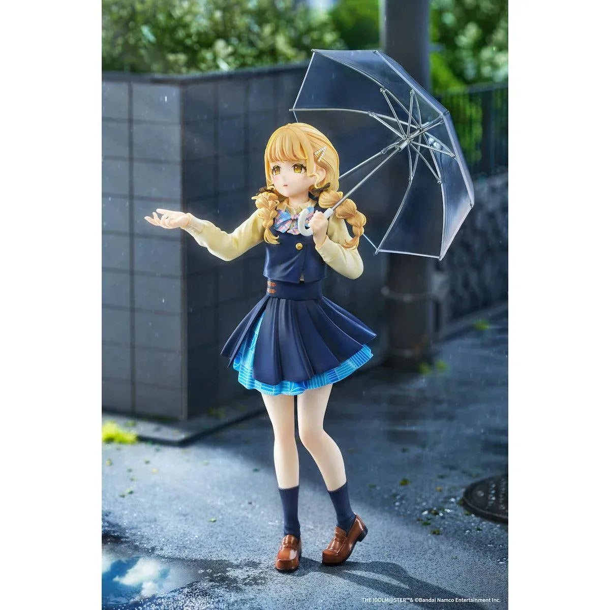 Gakuen iDOLM@STER Kotone Fujita Ameagari no Iris Before Special Training Ver. 1/7 Scale Figure featuring a blonde-haired anime girl with twin braids wearing a navy-blue school uniform and holding a transparent umbrella on a yellow display base.