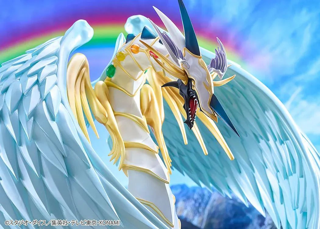 Yu-Gi-Oh! GX Rainbow Dragon figure with a pearlescent armored body, multicolored crystals, gold accents, and translucent blue wings.
