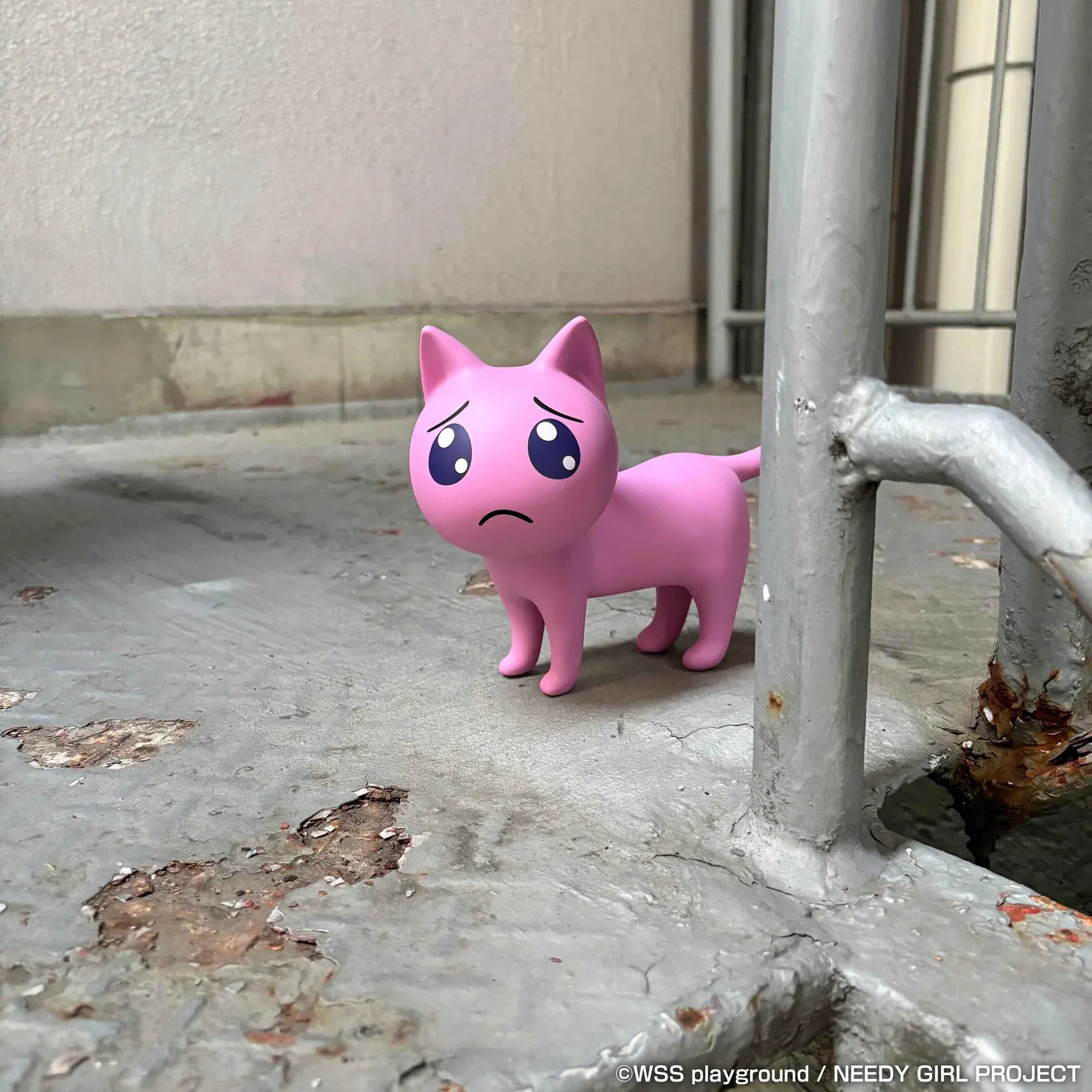 NEEDY GIRL OVERDOSE Pien Cat pink soft vinyl figure with large teary eyes and a worried expression.