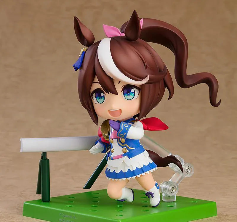Umamusume Pretty Derby Nendoroid Tokai Teio rerelease figure with brown hair, a white forelock, pink bow, and blue-and-white racing uniform.