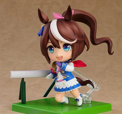 Umamusume Pretty Derby Nendoroid Tokai Teio rerelease figure with brown hair, a white forelock, pink bow, and blue-and-white racing uniform.