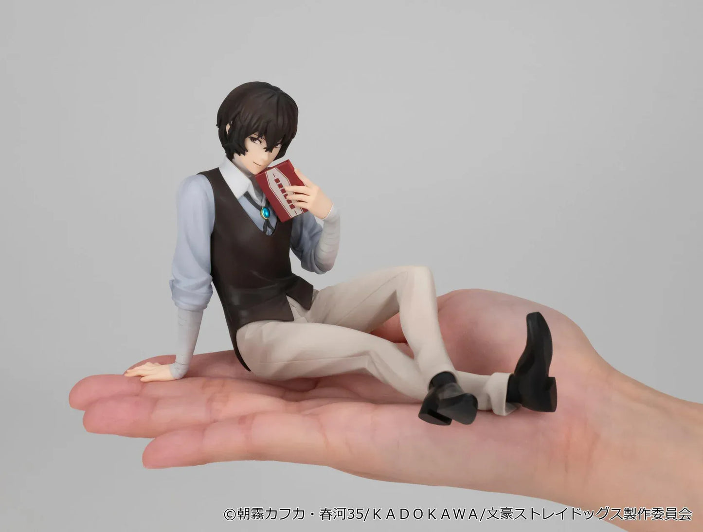 Bungo Stray Dogs G.E.M. Series Dazai-san Palm Size Figure seated and holding a book
