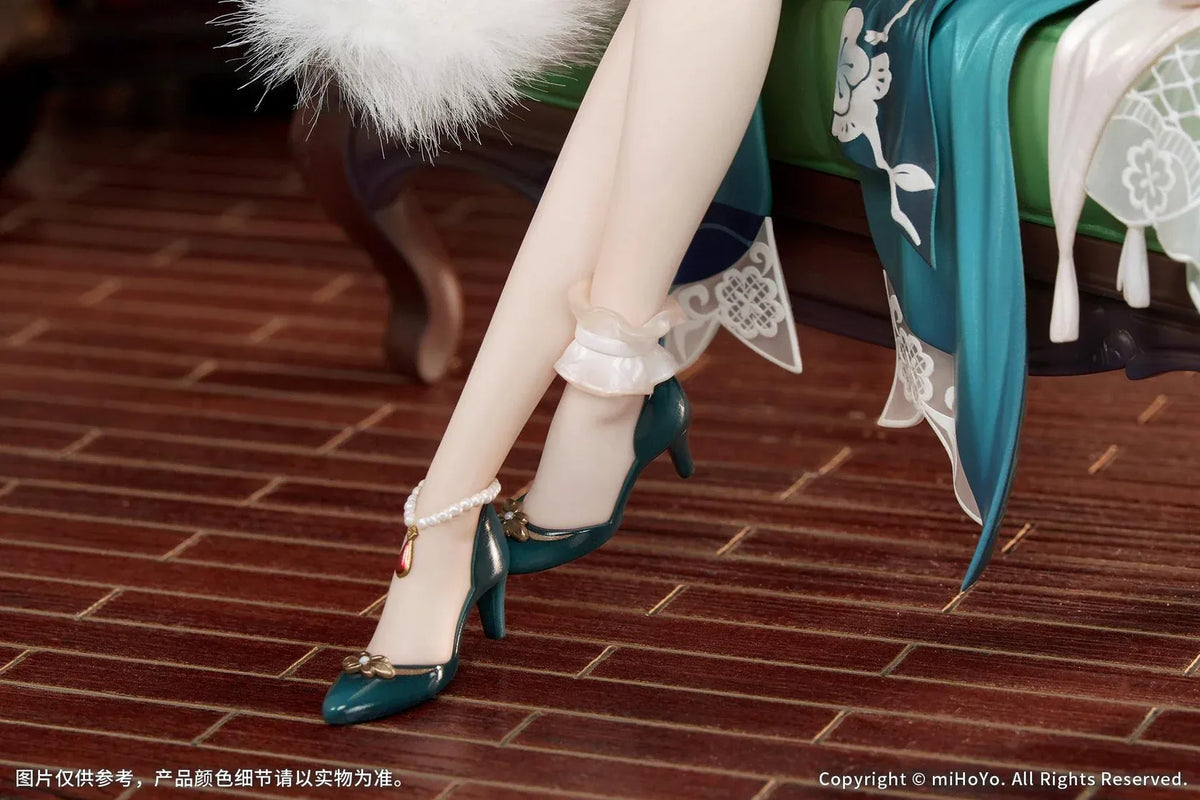 Ruan Mei Plumblossom Letter 1/7 scale figure wearing an elegant teal-and-white floral dress while seated on an ornate green sofa.