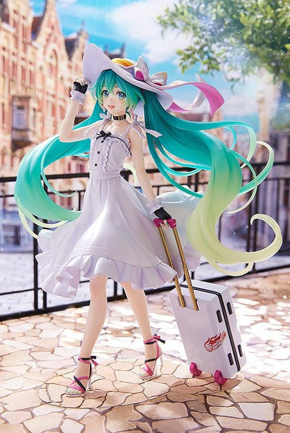 Racing Miku 2021 Private Ver. figure in a white dress and wide-brimmed hat, with turquoise twin-tails and a rolling suitcase on a stone-style base.