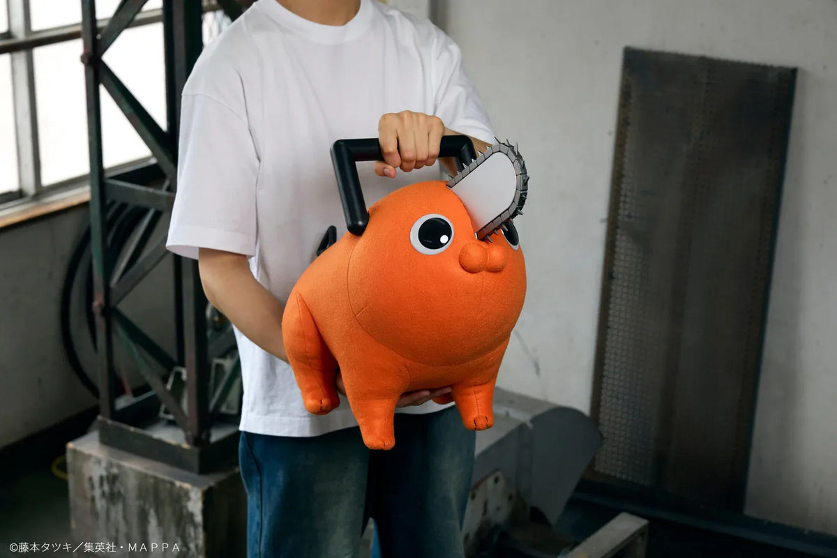Chainsaw Man life-size Pochita doll figure with an orange body, glossy eyes, chainsaw blade, black handle, and pull cord.