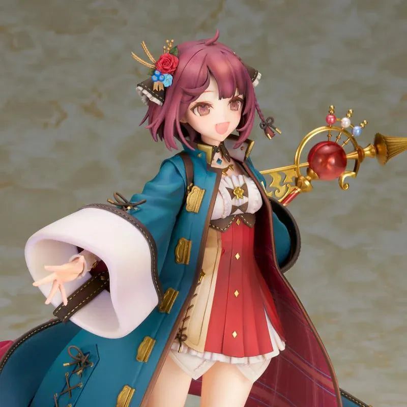 Sophie Neuenmuller figure smiling in a dynamic pose, wearing a teal coat over a red outfit and holding an ornate gold staff with a red orb.