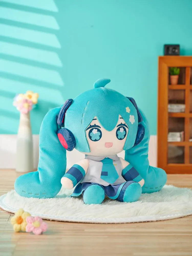 Hatsune Miku Huggy Doll plushie with turquoise twin tails, flower-shaped embroidered eyes, and her signature outfit.