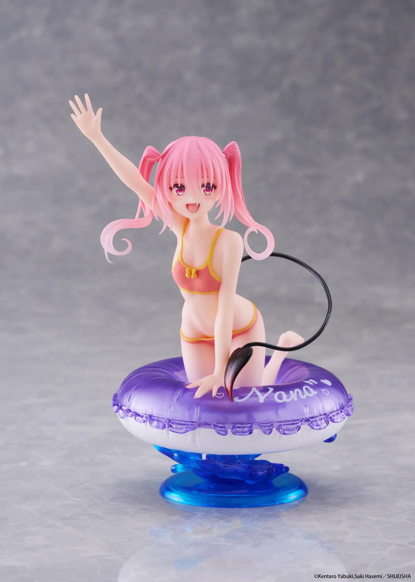 To Love-Ru Darkness Aqua Float Girls Nana figure featuring Nana with pink twin tails in a swimsuit posing on a purple float ring display base