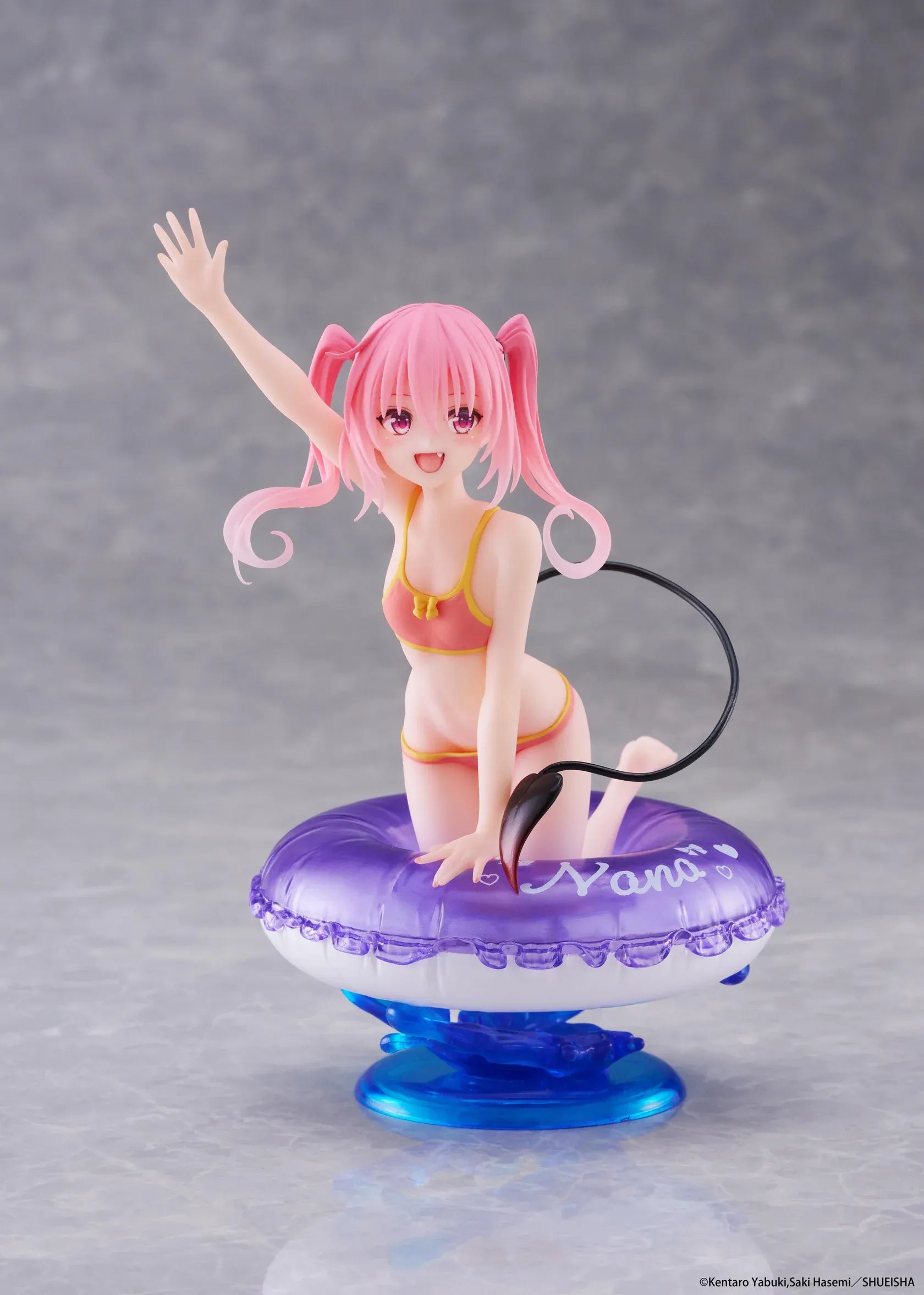 To Love-Ru Darkness Aqua Float Girls Nana figure featuring Nana with pink twin tails in a swimsuit posing on a purple float ring display base