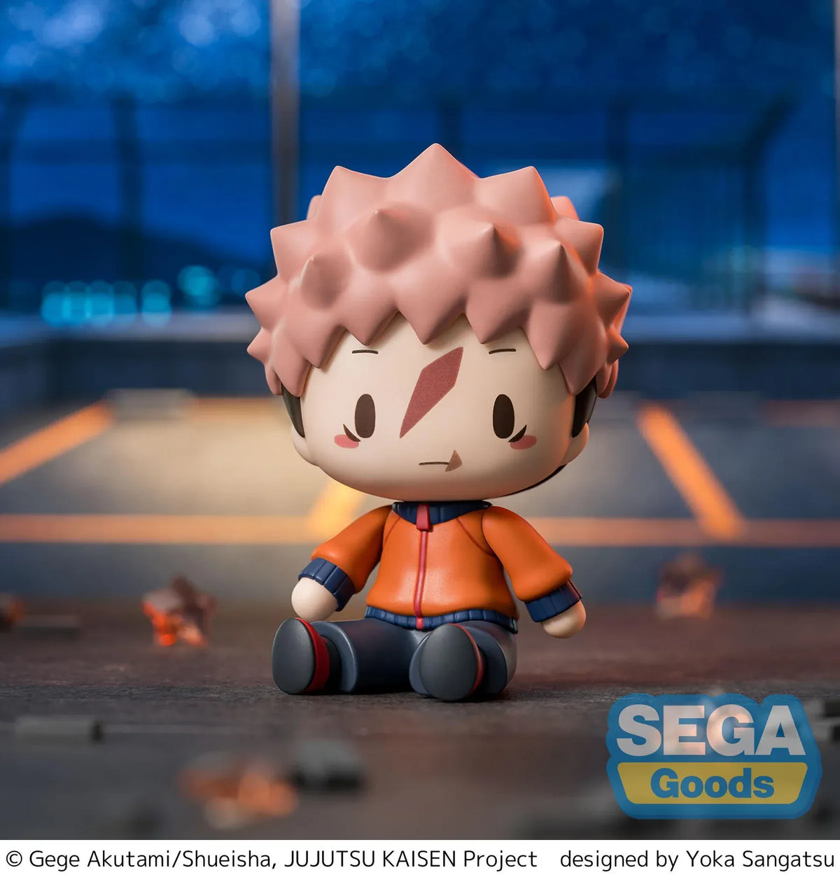 Yuji Itadori chibi figure in a seated pose with pink hair, facial markings, and an orange and navy outfit.