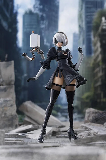 NieR Ver1.1a figma 2B figure with silver hair, a black visor, patterned black outfit, white sleeves, glossy boots, and a support robot.