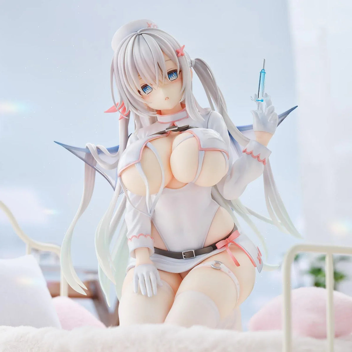 Succubus Nurse Makina figure kneeling in a white and pink nurse outfit with silver hair, batlike wings, a demon tail, and a translucent syringe.