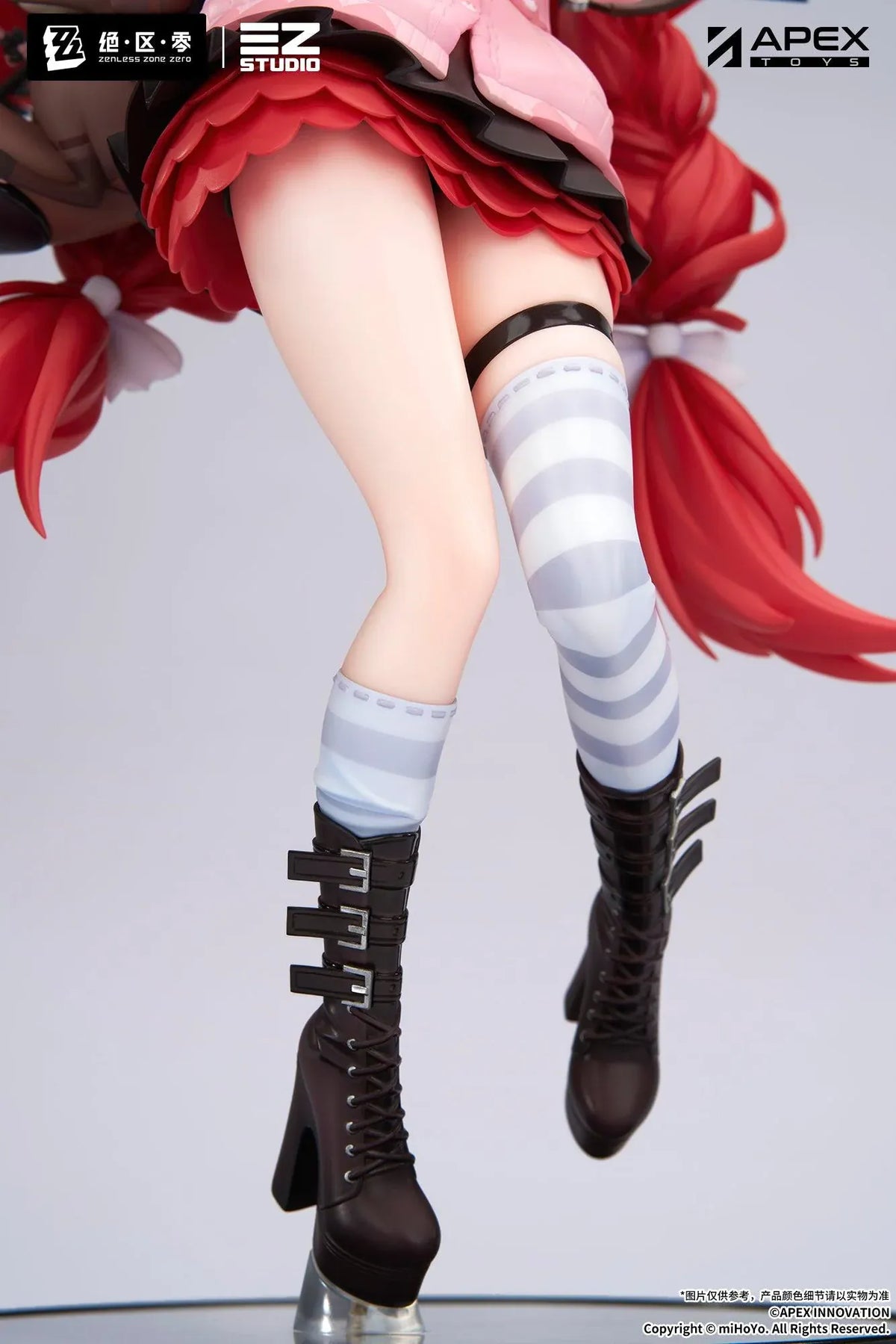 Zenless Zone Zero Yuzuha Ukinami 1/7 Scale Figure by APEX Toys featuring a red-haired anime girl with long braided twin-tails, green eyes, a pink jacket, layered red skirt, striped thigh-high stockings, and black boots while holding a large red umbrella on a circular display base.