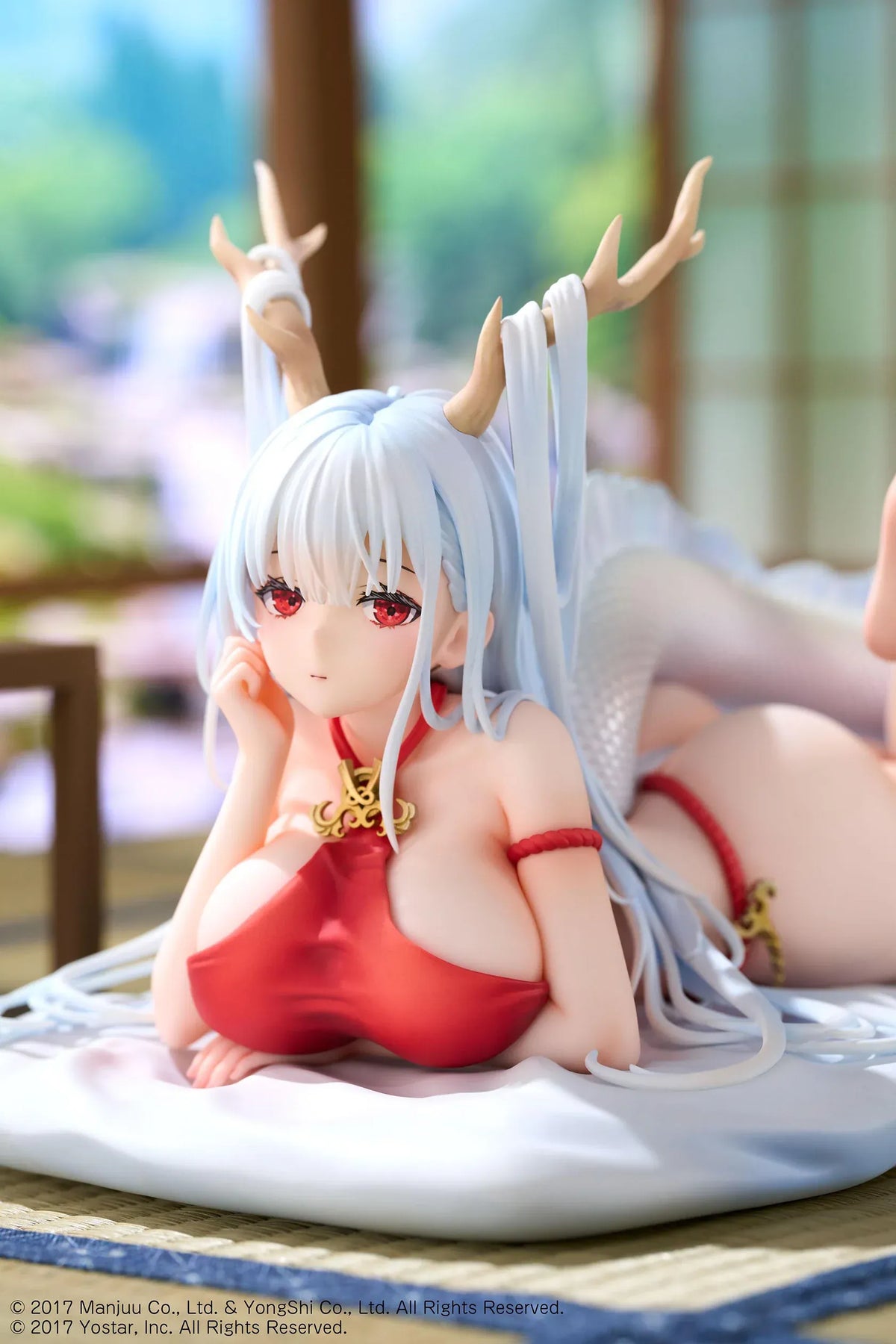 Azur Lane Shimanto 1/7 scale figure reclining on a pale cushion with icy-blue hair, branching horns, a red outfit, and a curling dragon tail.