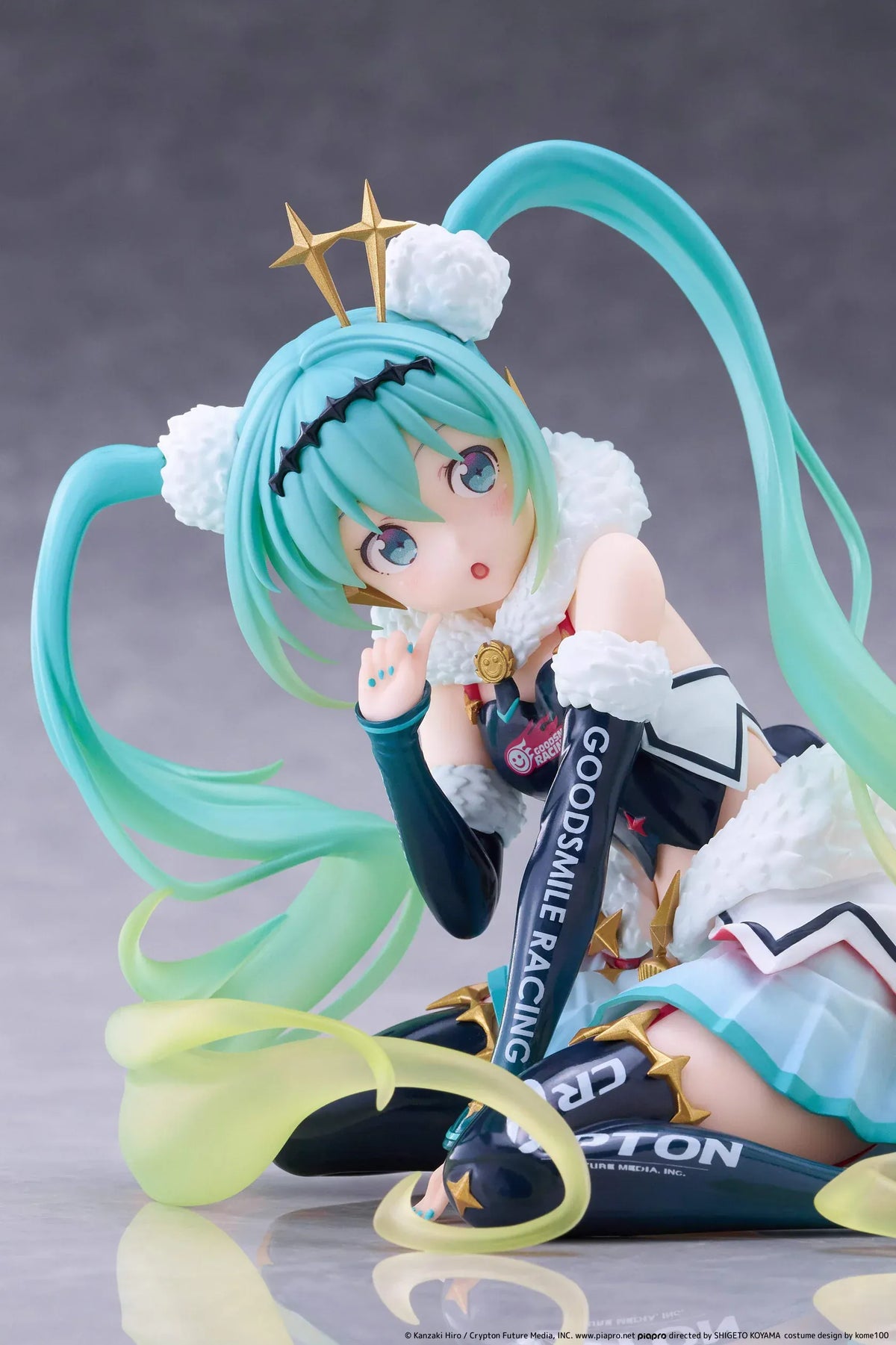Racing Miku 2018 Ver. Round 8 figure seated in a white, black, and turquoise racing outfit with long gradient twin tails.