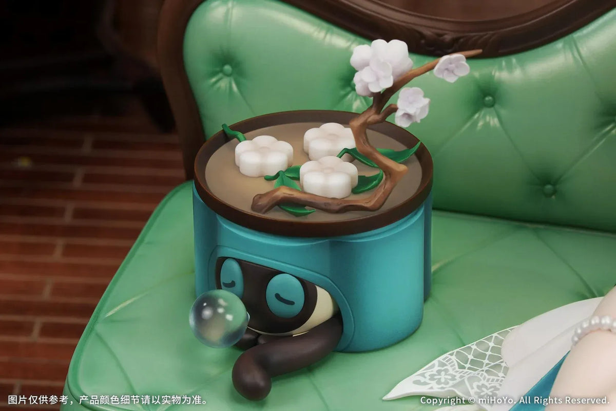 Ruan Mei Plumblossom Letter 1/7 scale figure wearing an elegant teal-and-white floral dress while seated on an ornate green sofa.