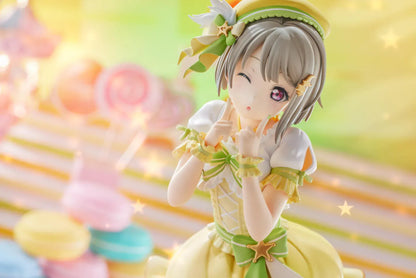 Love Live Nijigasaki High School Idol Club Kasumi Nakasu 1/7 Scale Figure featuring Kasumi in a yellow and green idol outfit with a winking expression, ribbon accents, and matching boots.