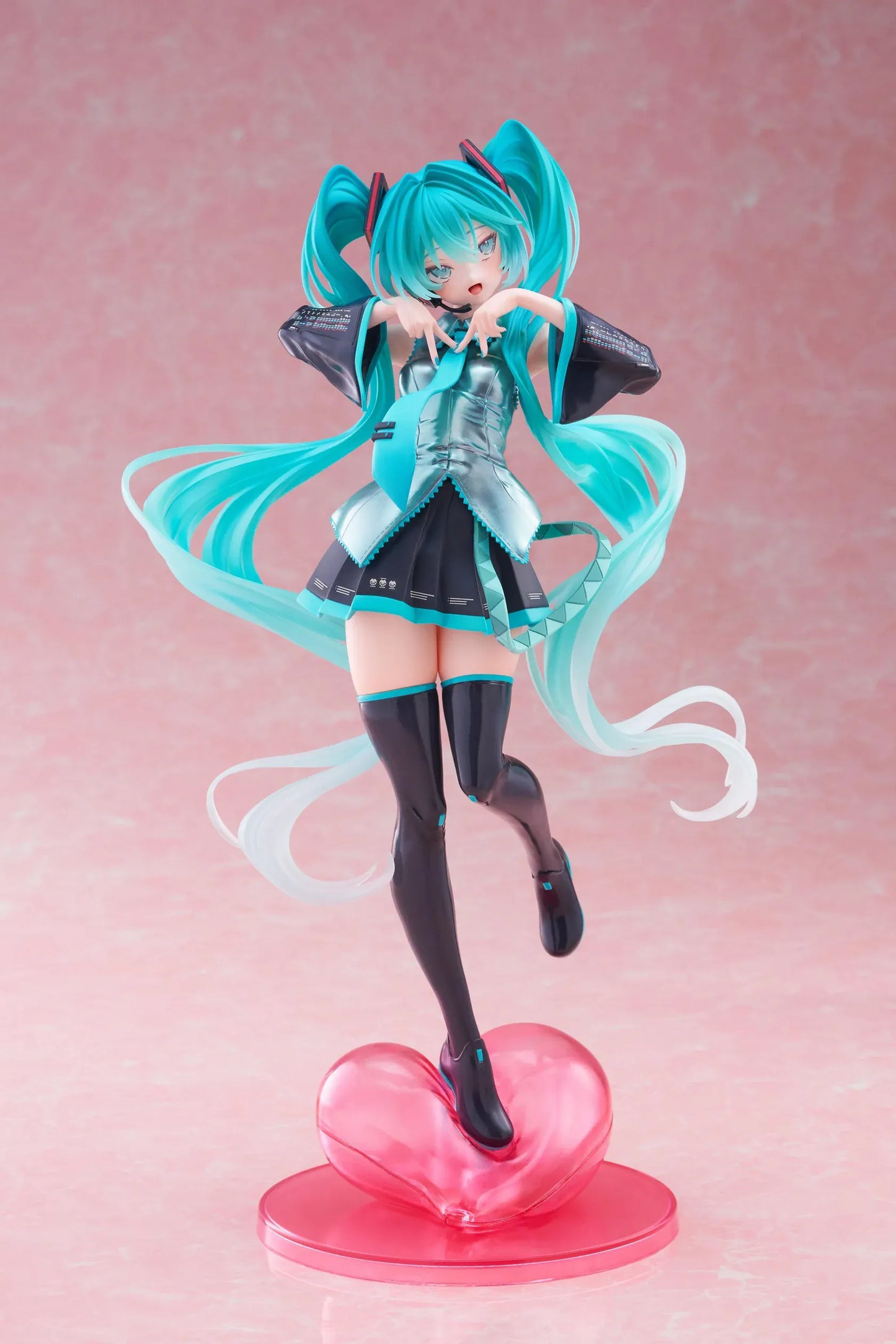 Hatsune Miku T-Most figure with flowing twin tails, classic Vocaloid outfit, and pink heart-shaped display base