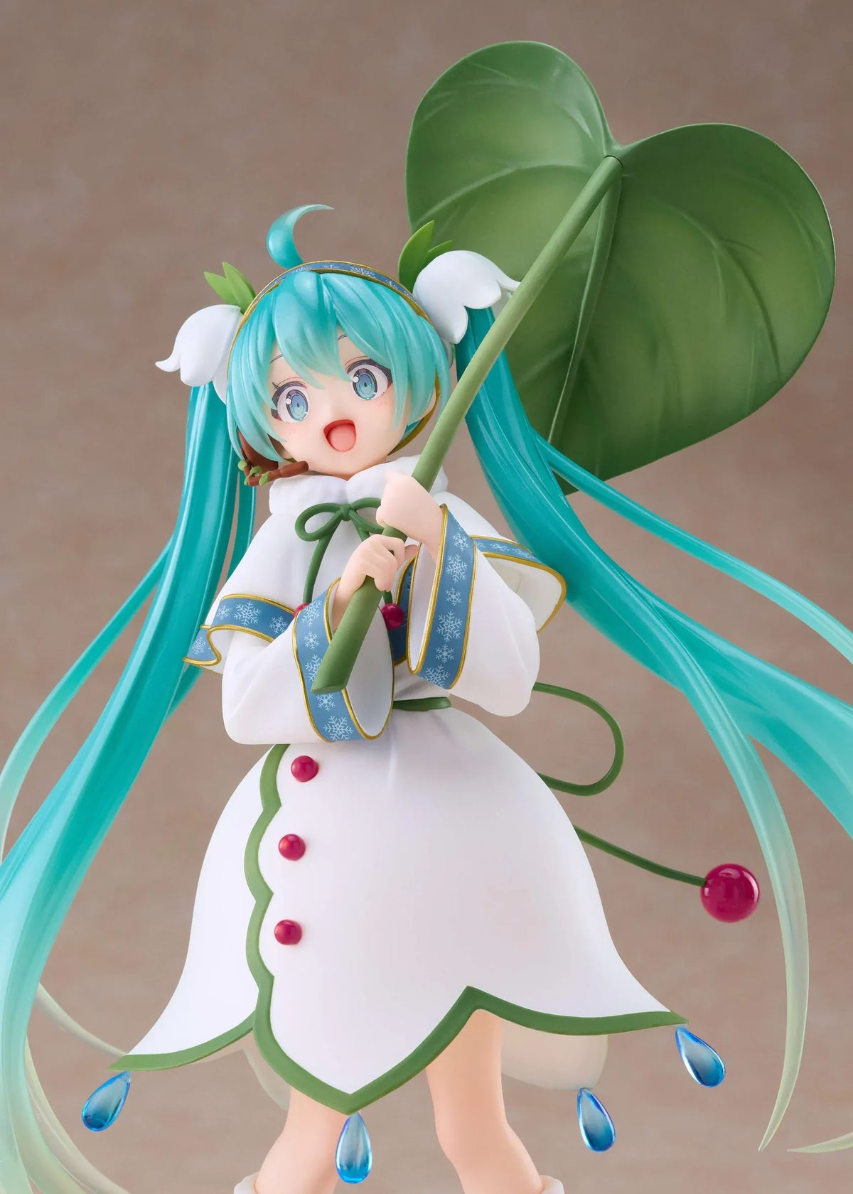 Snow Miku All Stars 2015 Ver. AMP+ figure wearing a white flower-inspired dress and holding an oversized green leaf.