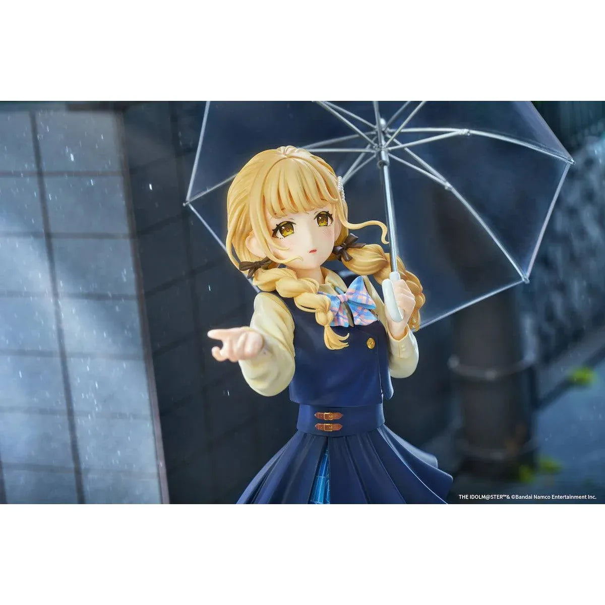 Gakuen iDOLM@STER Kotone Fujita Ameagari no Iris Before Special Training Ver. 1/7 Scale Figure featuring a blonde-haired anime girl with twin braids wearing a navy-blue school uniform and holding a transparent umbrella on a yellow display base.