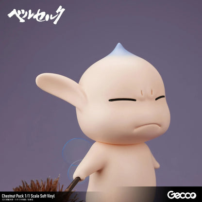 Berserk Chestnut Puck 1/1 Scale Soft Vinyl Figure by Gecco featuring a small cream-colored elf with oversized pointed ears, a tiny blue hair tuft, closed eyes, a grumpy expression, and a rounded body holding a large spiky brown chestnut burr.