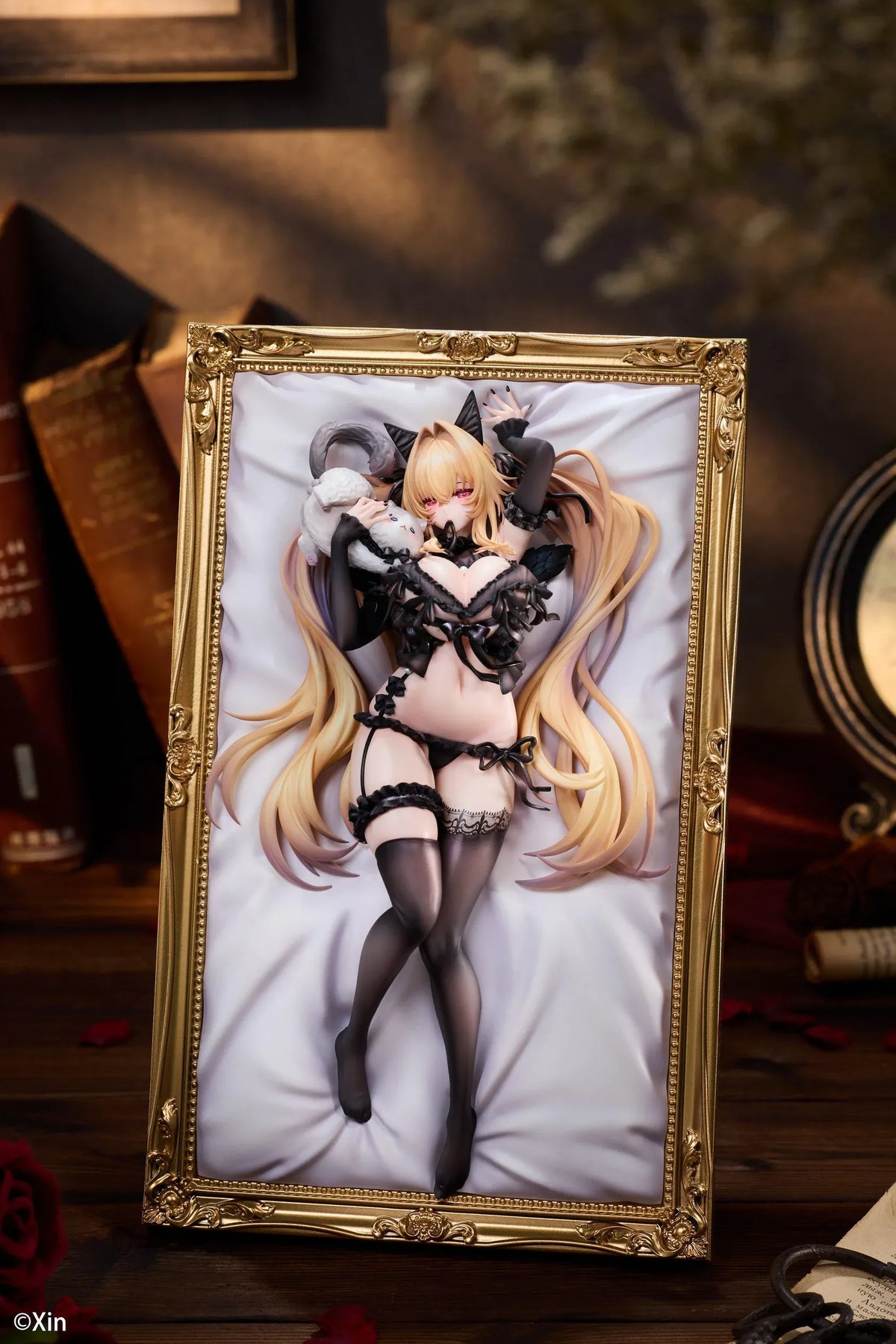 Stella Black Cat Ver. Deluxe Edition 1/7 Scale Figure illustrated by Xin, featuring a blonde-haired catgirl with red eyes, black lace lingerie, cat ears, and thigh-high stockings displayed in an ornate golden frame with a matching illustrated wall scroll.