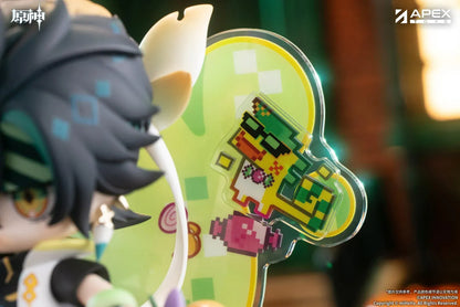 Genshin Impact You Ye Qi Xiang Series chibi Kinich figure holding a lollipop, surrounded by candy, a pumpkin, and a pixel-art backdrop.