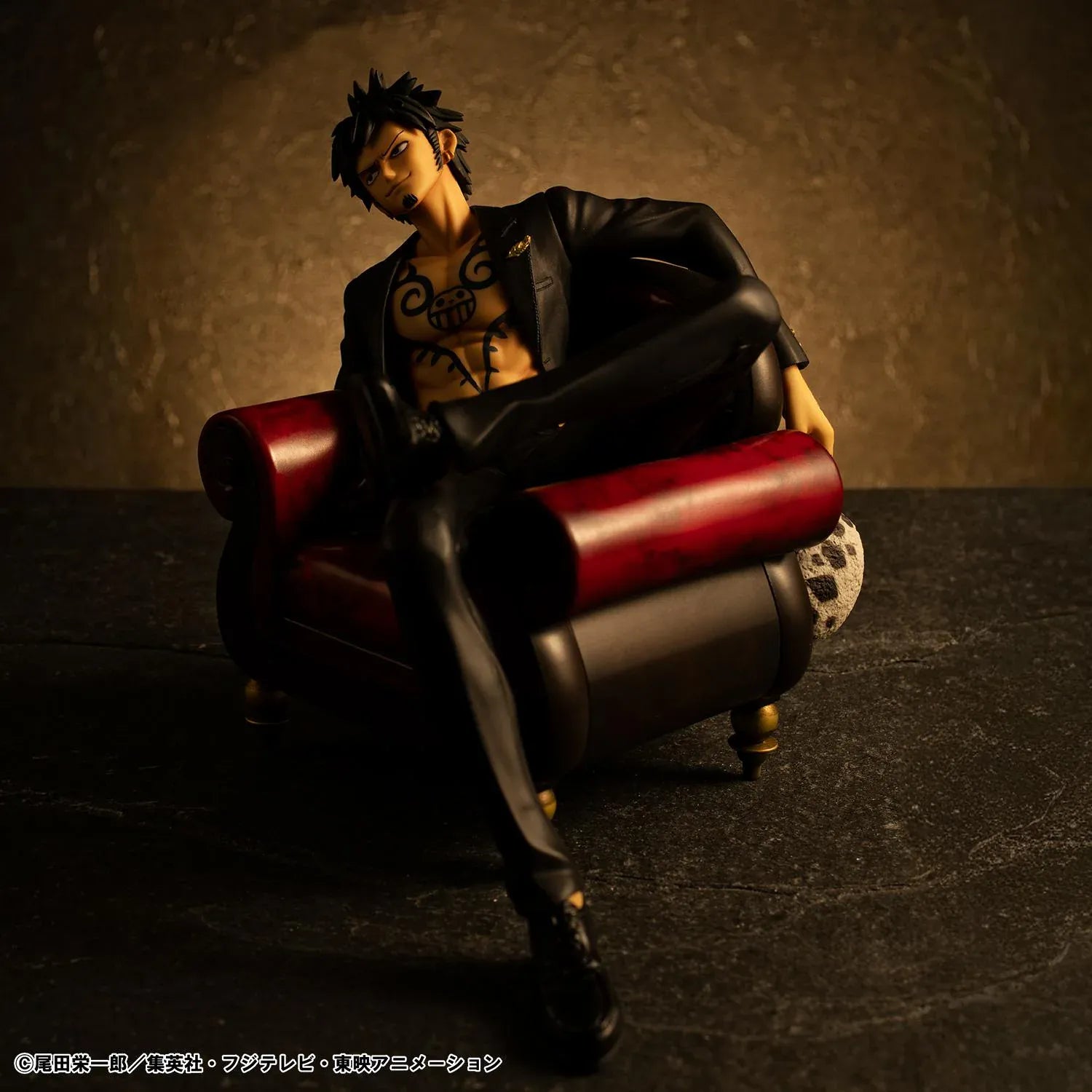 One Piece Portrait Of Pirates S.O.C. Trafalgar Law Ver. R Figure wearing a black suit and sitting in a red armchair