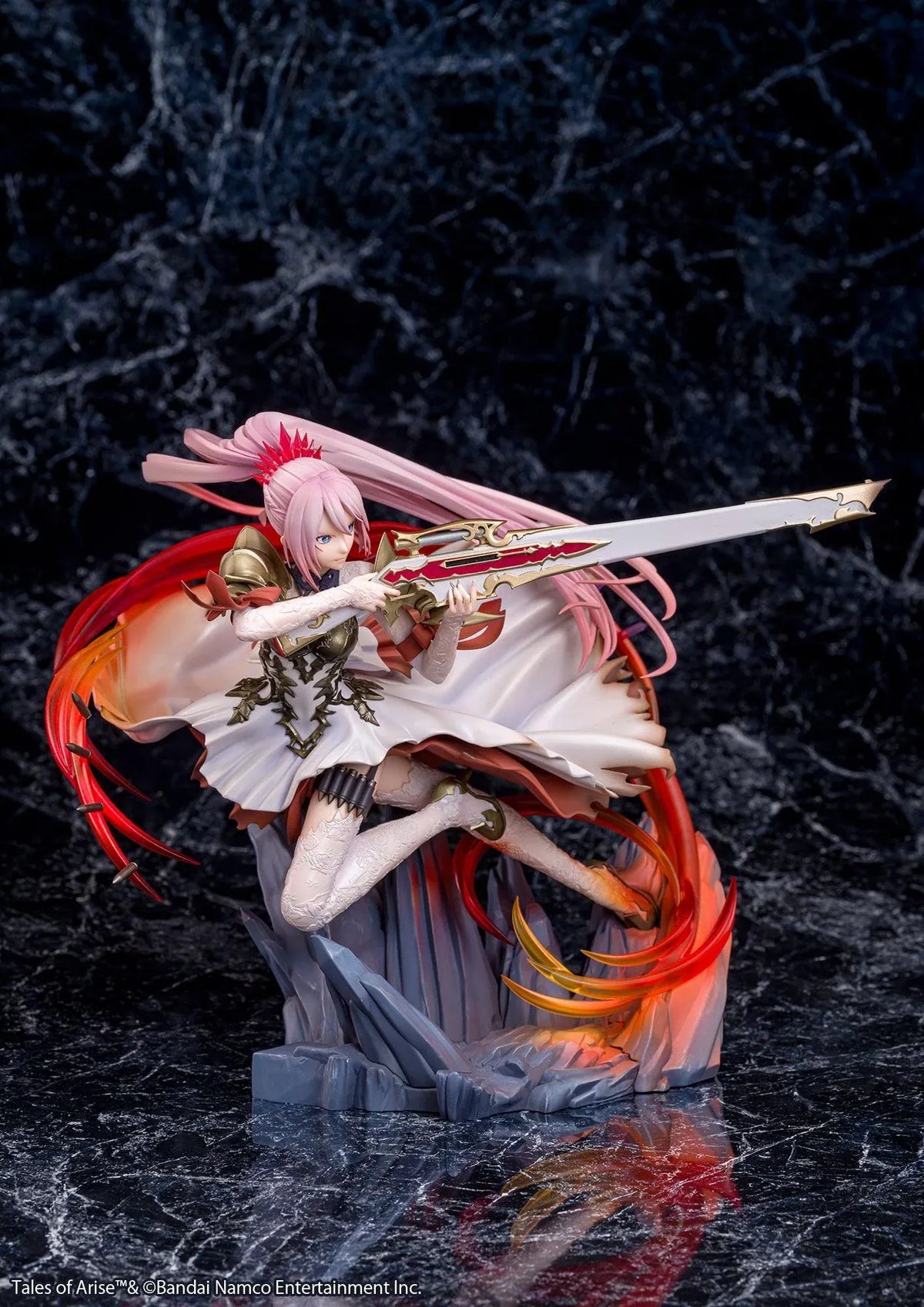 Tales of Arise Shionne 1/7 Scale Figure featuring a pink-haired anime character with blue eyes, an ornate white battle dress, gold armor, and lace stockings, aiming a detailed rifle while suspended in a dynamic pose surrounded by translucent red and orange effects on a rocky display base.