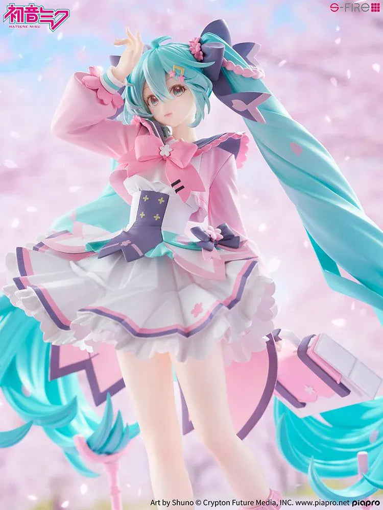 Hatsune Miku New School Term figure with turquoise twin-tails, a pink and white ruffled outfit, purple bows, and flower accents on a pink base.