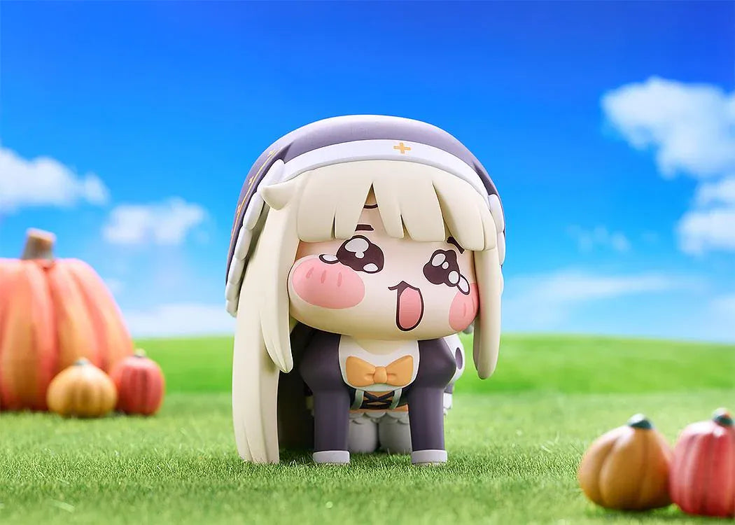 Petite Speaki soft vinyl figure with blonde hair, rosy cheeks, sparkling eyes, and a dark hood with gold accents.