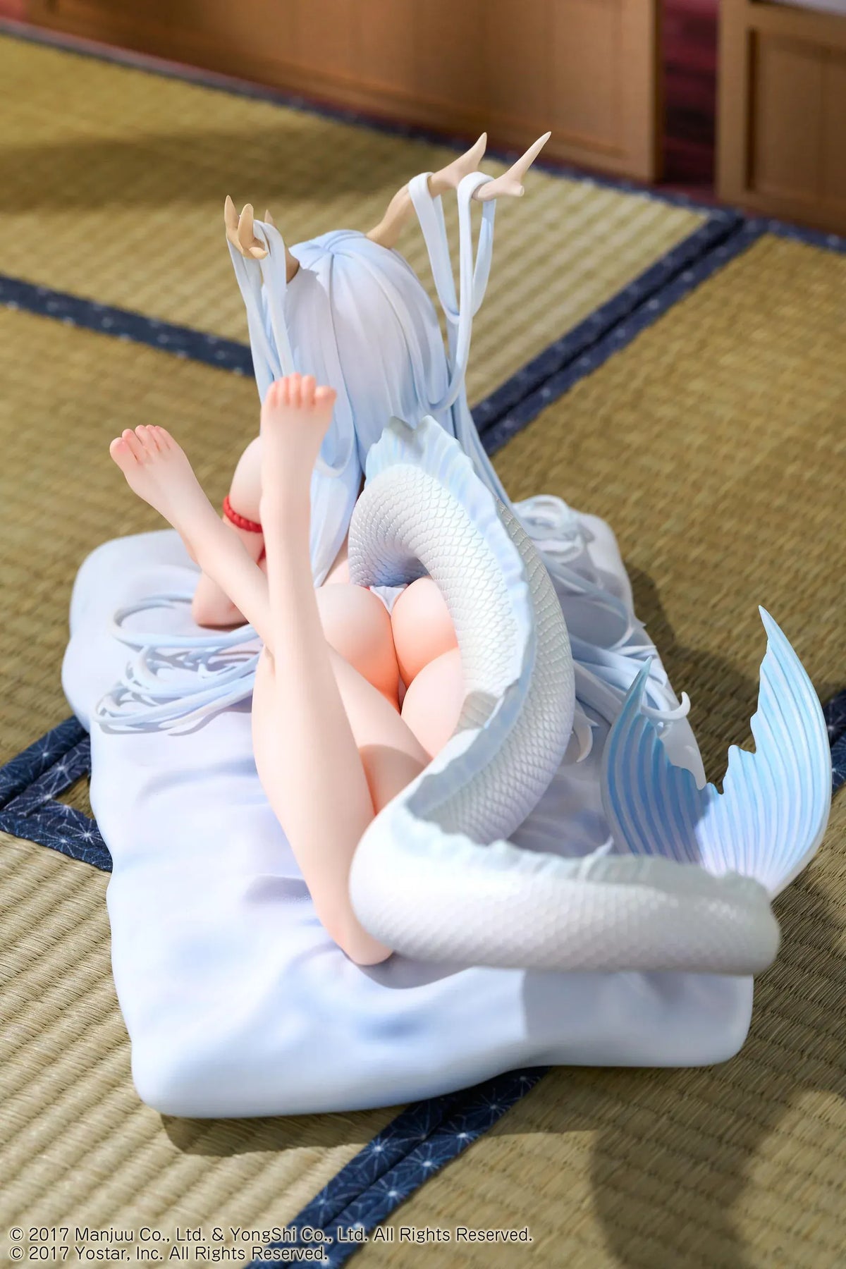 Azur Lane Shimanto 1/7 scale figure reclining on a pale cushion with icy-blue hair, branching horns, a red outfit, and a curling dragon tail.