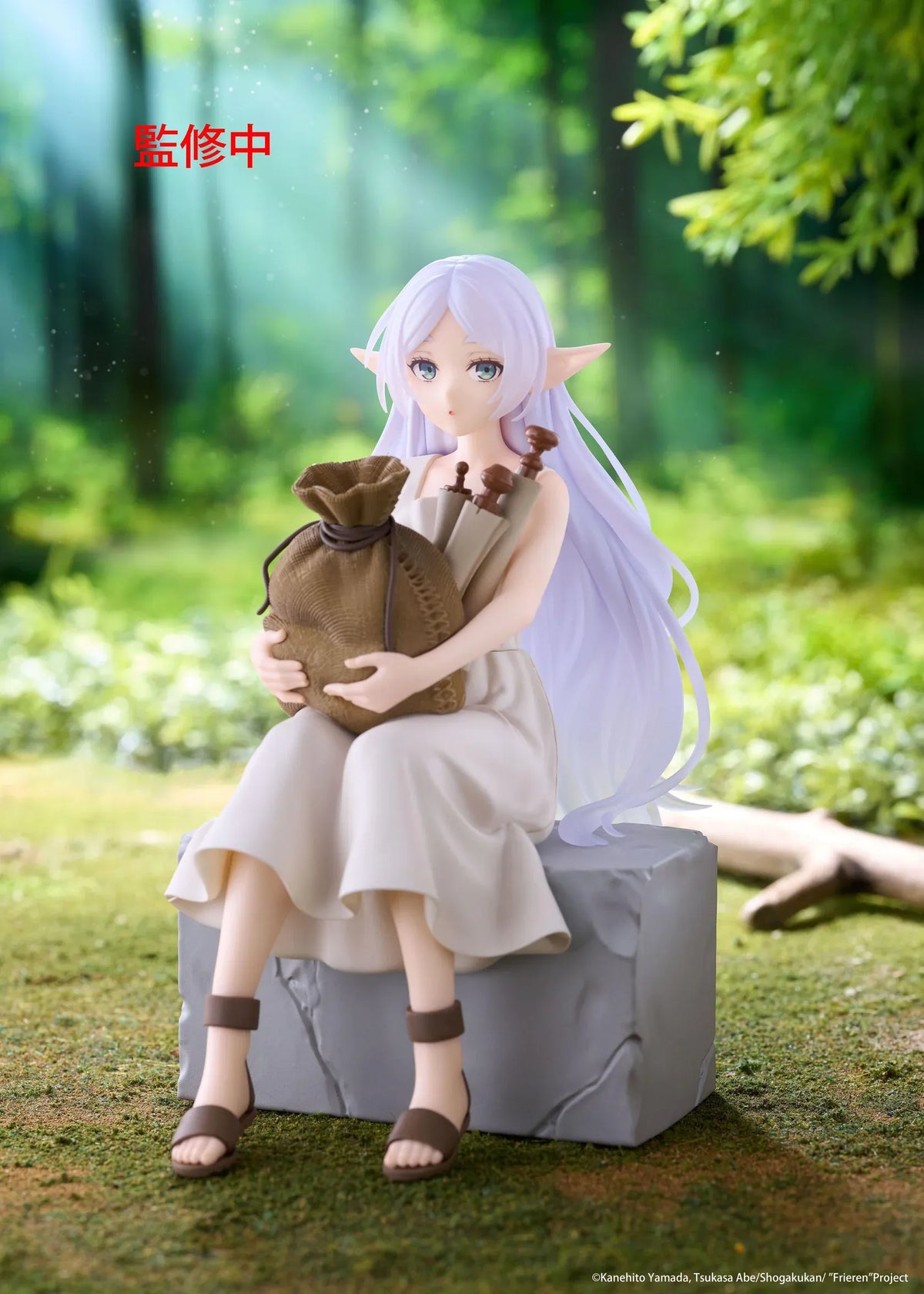 Desktop Cute Frieren In Training Ver. figure seated on a gray stone block, wearing a cream dress and brown sandals while holding a sack beside rolled scrolls.