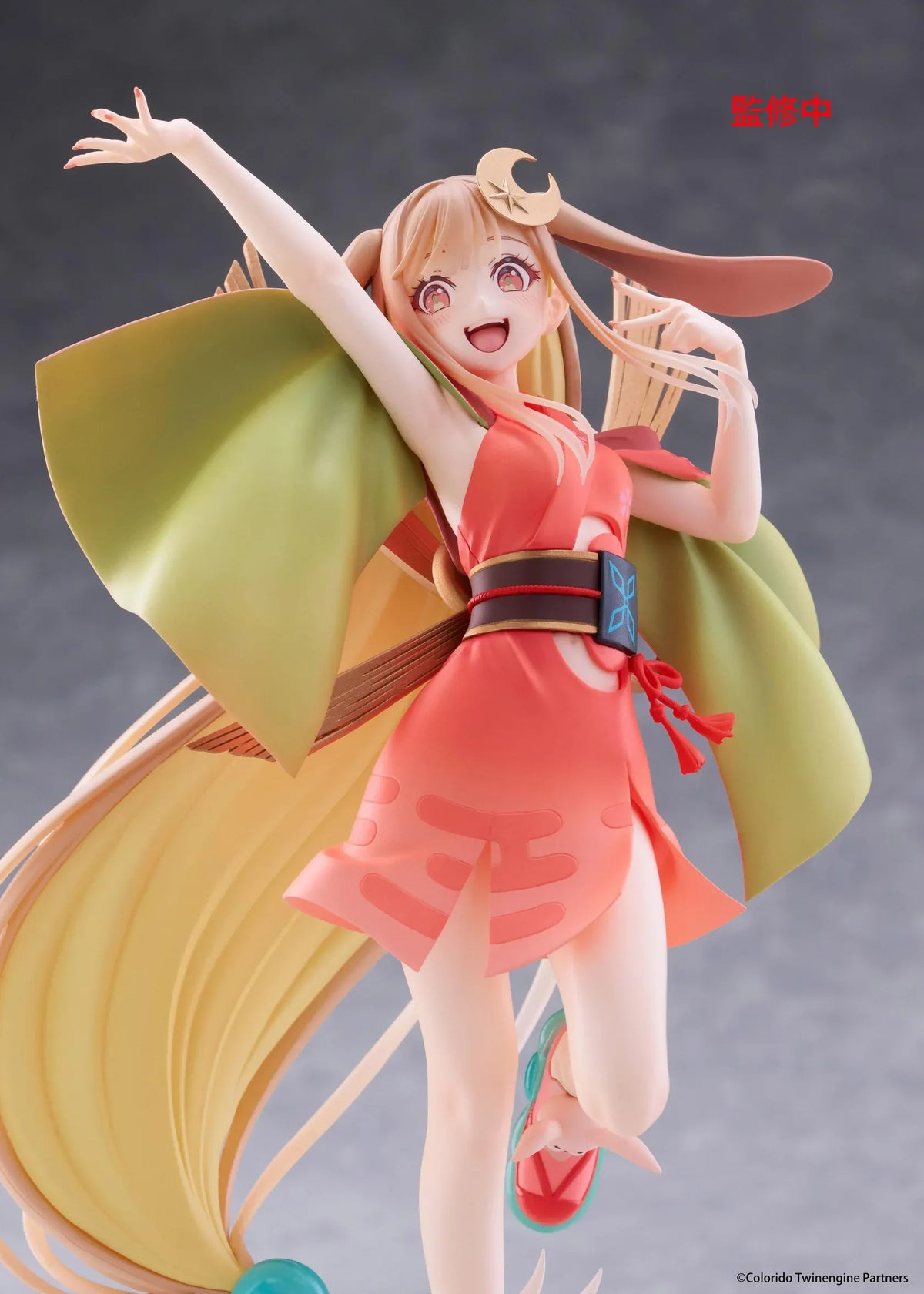 Cosmic Princess Kaguya! Kaguya VR Ver. Coreful Figure featuring a blonde-haired anime girl with pink eyes, long flowing hair, bunny ears, a crescent moon hair accessory, a coral-pink outfit with green sleeves, and colorful shoes in an energetic pose on a transparent circular base.