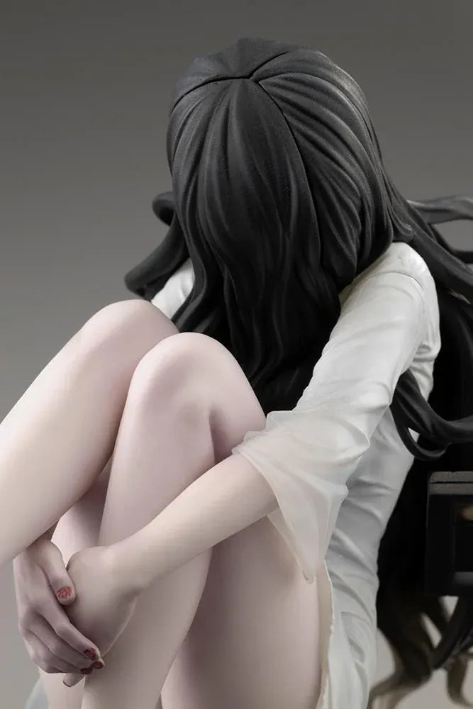 Sadako BISHOUJO Sadako 1/7 Scale Figure (Rerelease) featuring a long black-haired horror character wearing a flowing white dress, seated above a pile of VHS tapes with tangled black film ribbons.