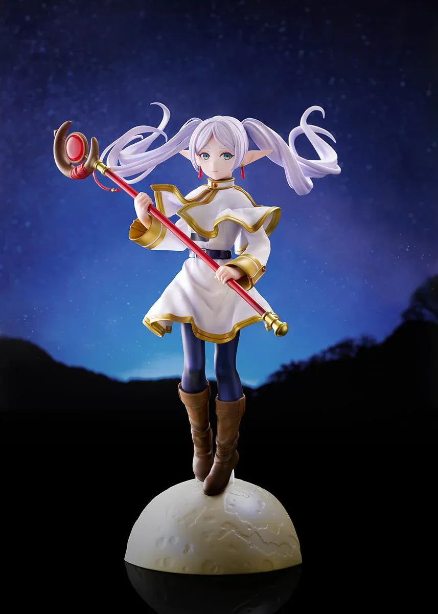 Frieren vs Aura 1/7 scale figure holding a red staff while wearing her white-and-gold mage outfit on a rounded display base.